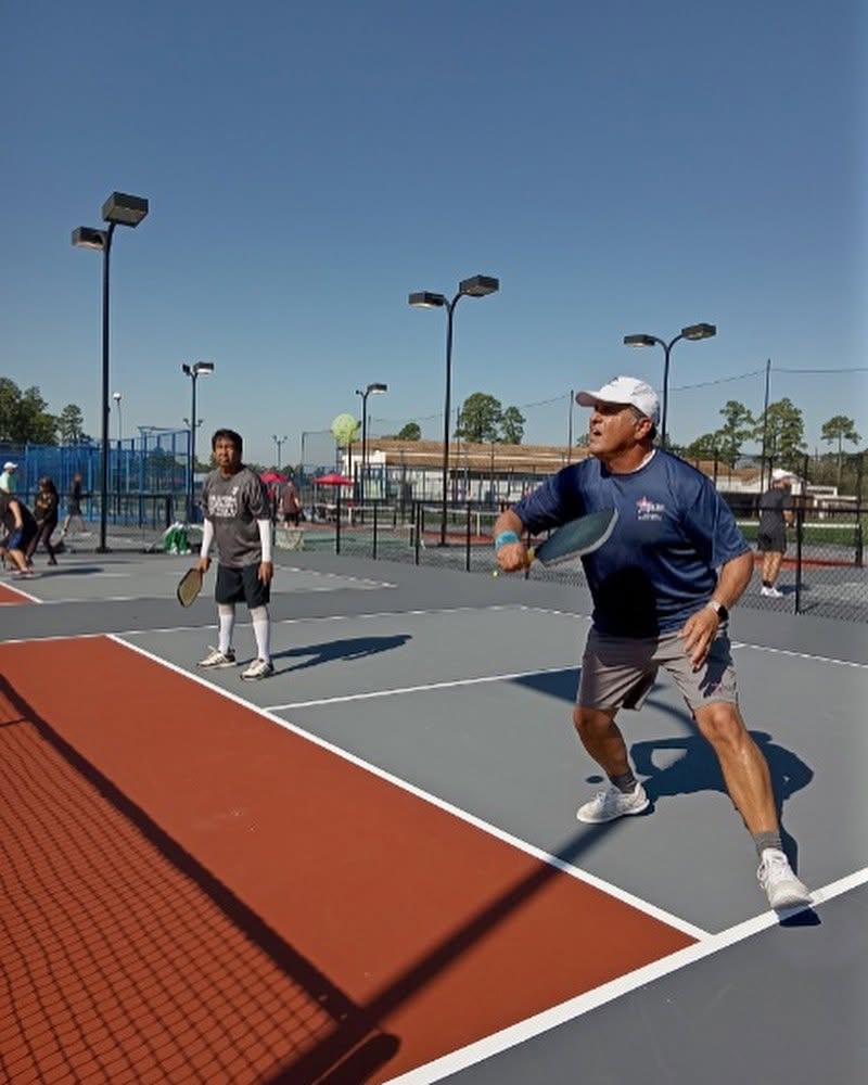 Doubles play on an outdoor court